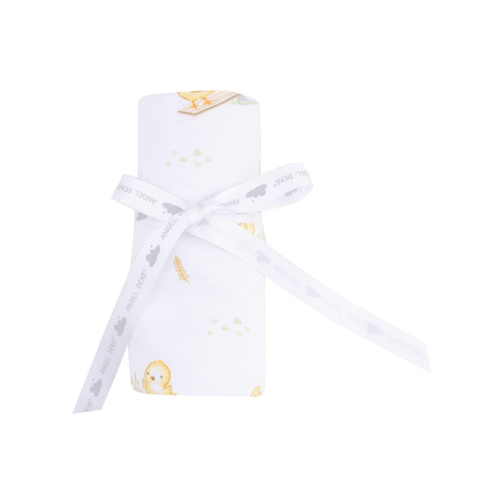 baby blanket rolled and tied with a ribbon , the way it would be sold to a customer. 