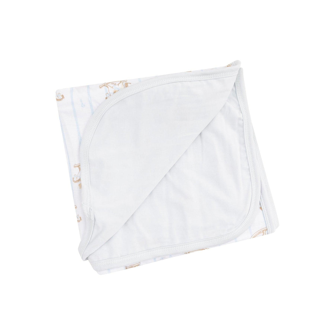double ply bamboo swaddle with gray backing in solid color and on the other its white, blue stripe and rocking horse with teddy bears on it. 