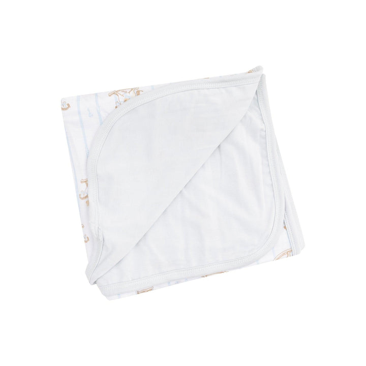 double ply bamboo swaddle with gray backing in solid color and on the other its white, blue stripe and rocking horse with teddy bears on it. 
