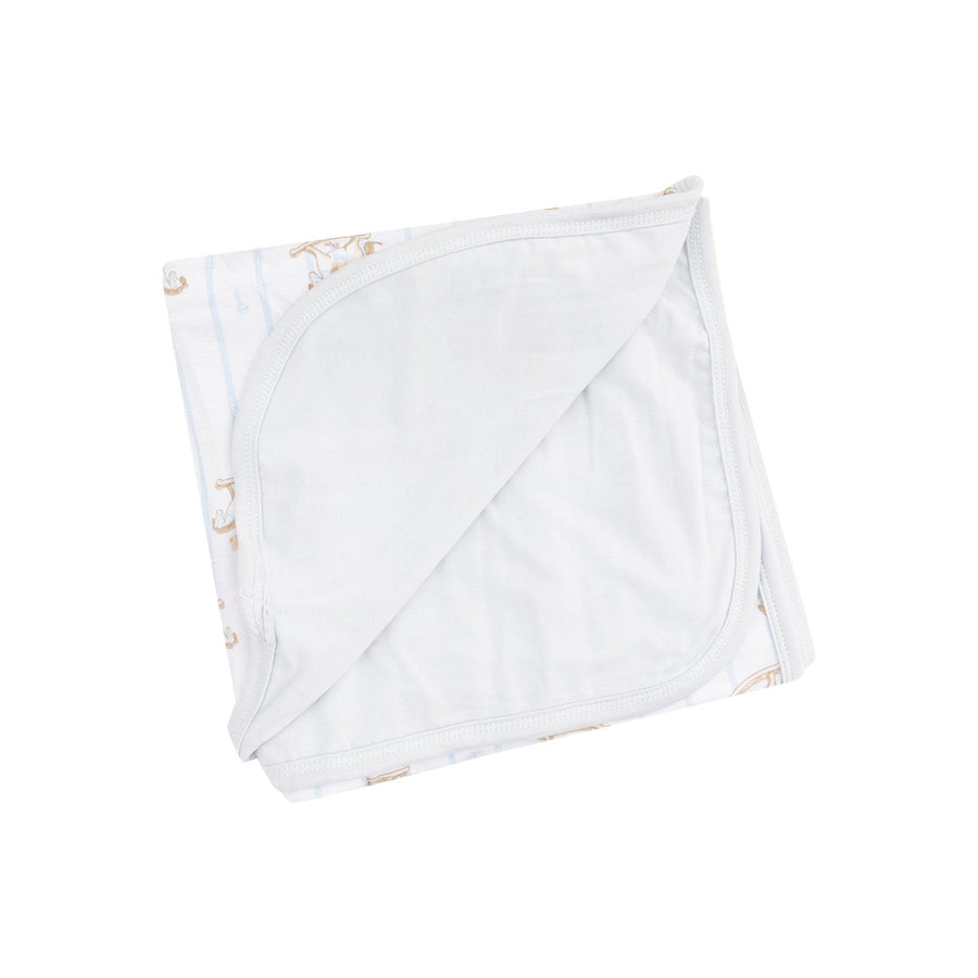 double ply bamboo swaddle with gray backing in solid color and on the other its white, blue stripe and rocking horse with teddy bears on it. 