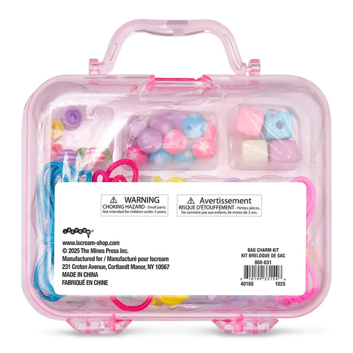 Pink container with colorful bag charm kit and warning label on a white background
