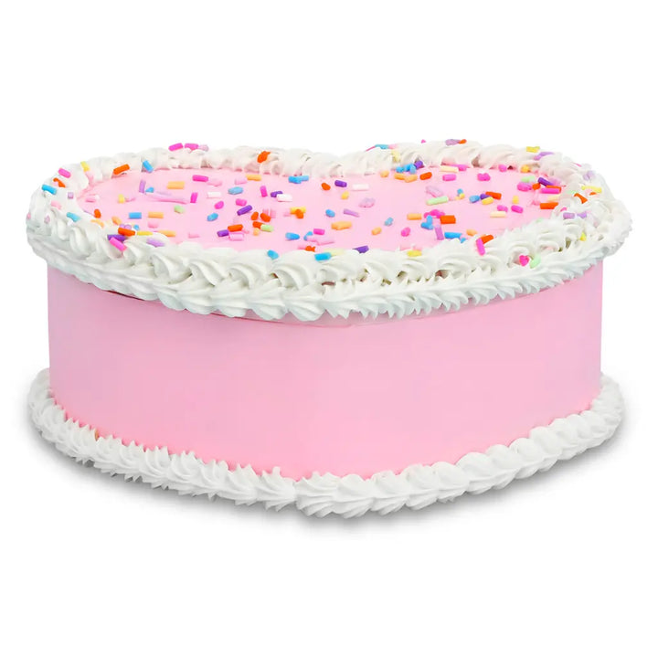 Pink cake with white frosting and colorful sprinkles on a white background