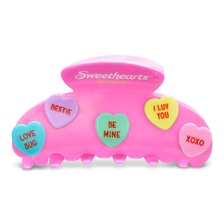 Pink hair clip with heart-shaped conversation bubbles and 'Sweethearts' branding on a white background