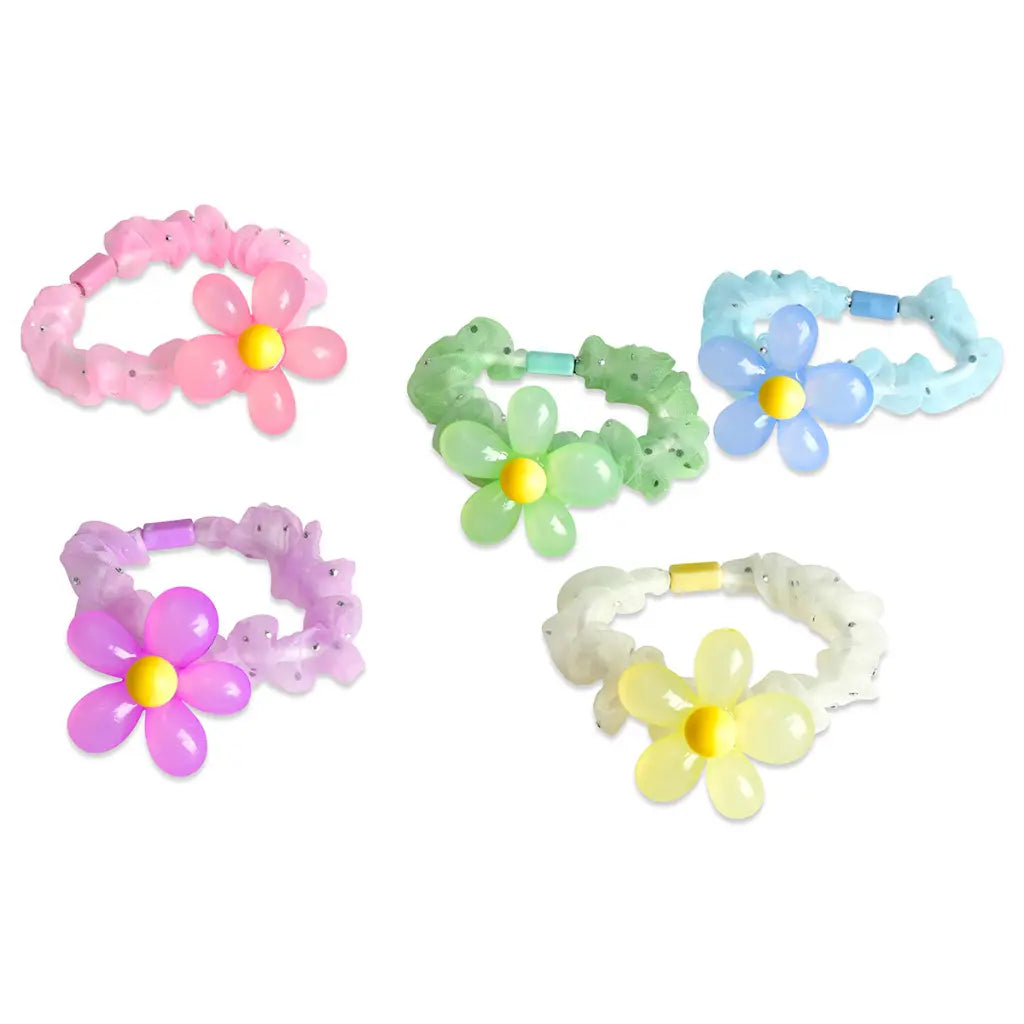 Set of colorful flower-shaped hair ties on a white background