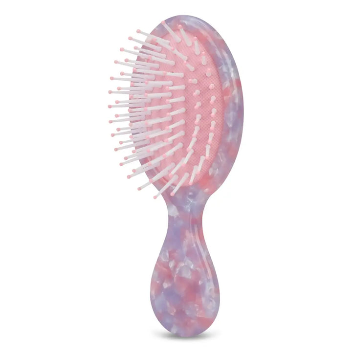 Marbled pink and purple hairbrush on a white background