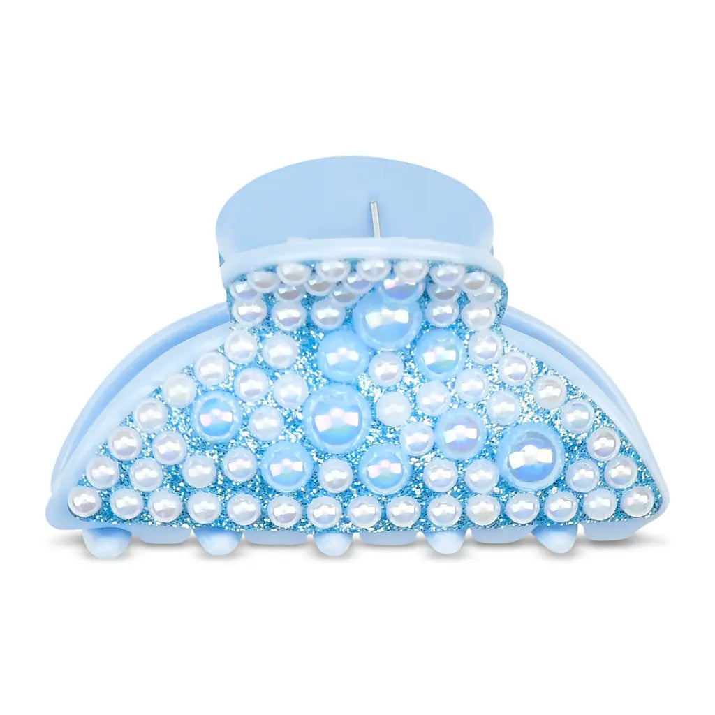 Blue claw clip with pearl-like beads on a white background