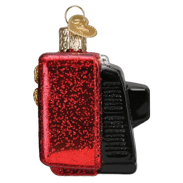 Decorative ornament resembling a vintage TV with red glittery body and black details on a white background.