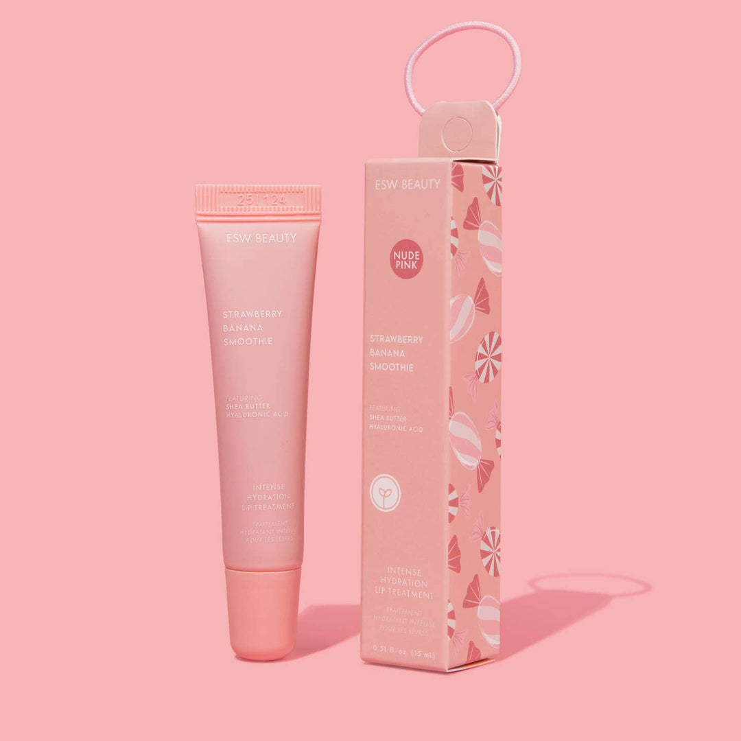 Pink lip balm product with packaging on a pink background