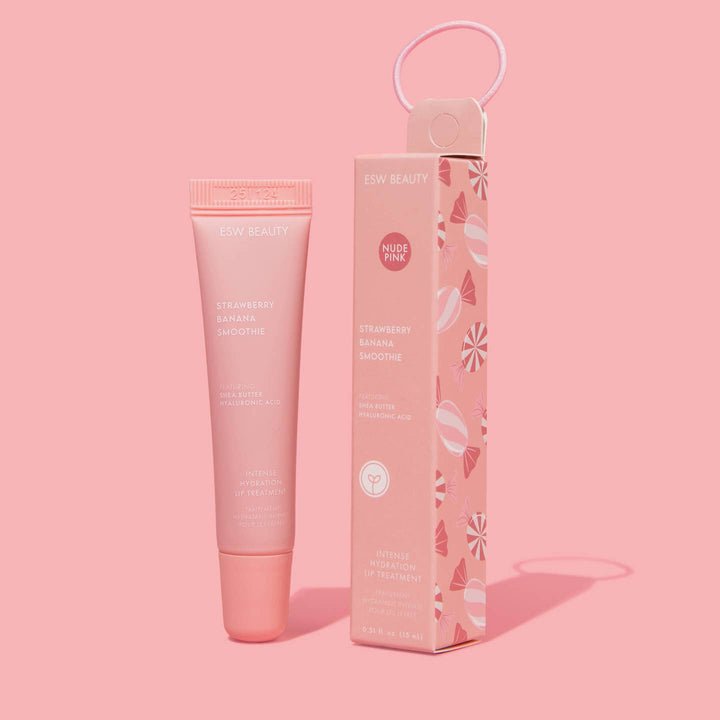 Pink lip balm product with packaging on a pink background