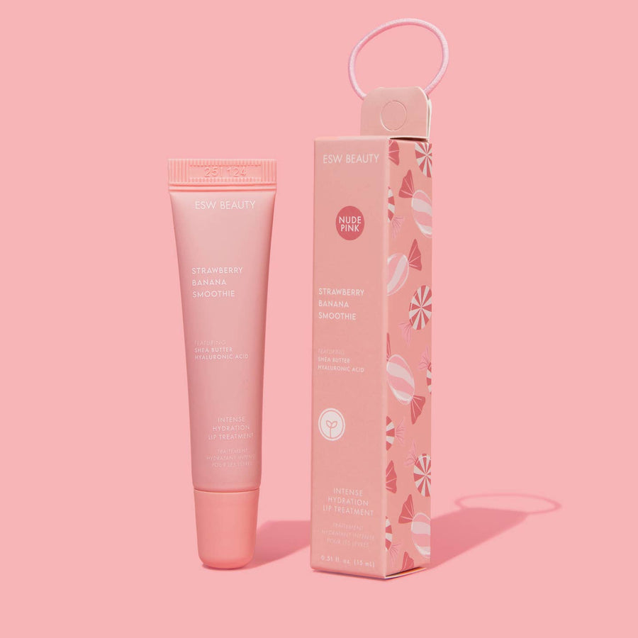 Pink lip balm product with packaging on a pink background