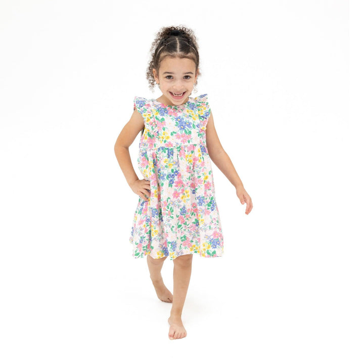 young girl modeling the pastel floral dress. it hits at the knee