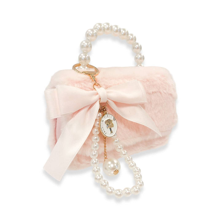 Pink decorative handbag with a bow, pearls, and a charm on a white background