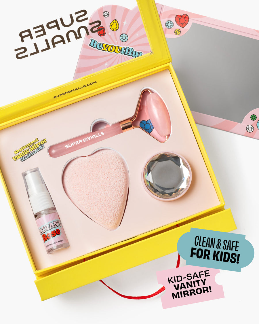 Super Smalls vanity mirror set with heart-shaped compact, bottle, and roller in a yellow box.