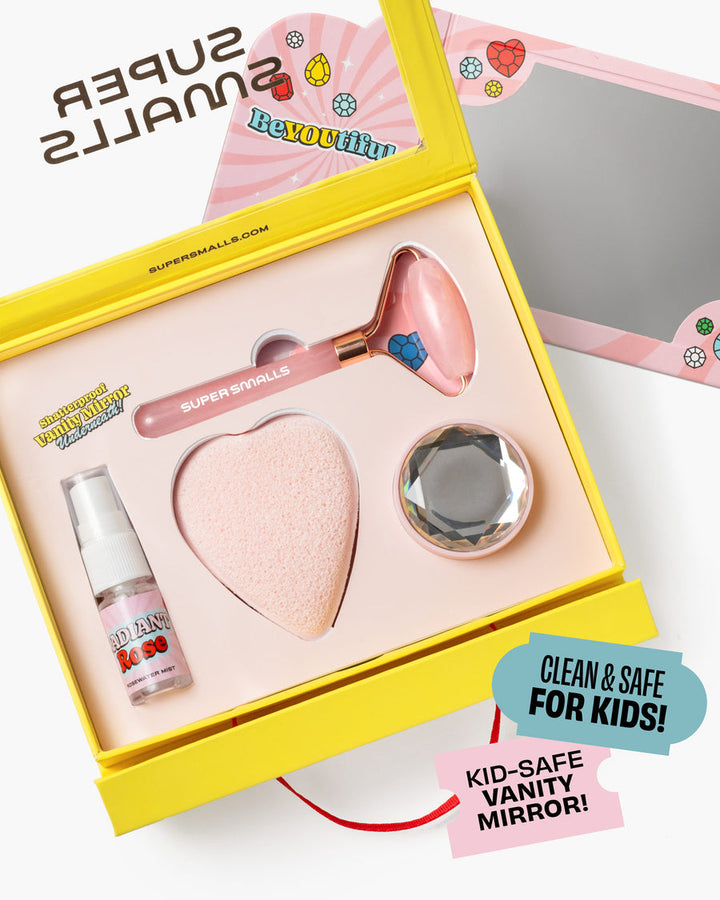 Super Smalls vanity mirror set with heart-shaped compact, bottle, and roller in a yellow box.