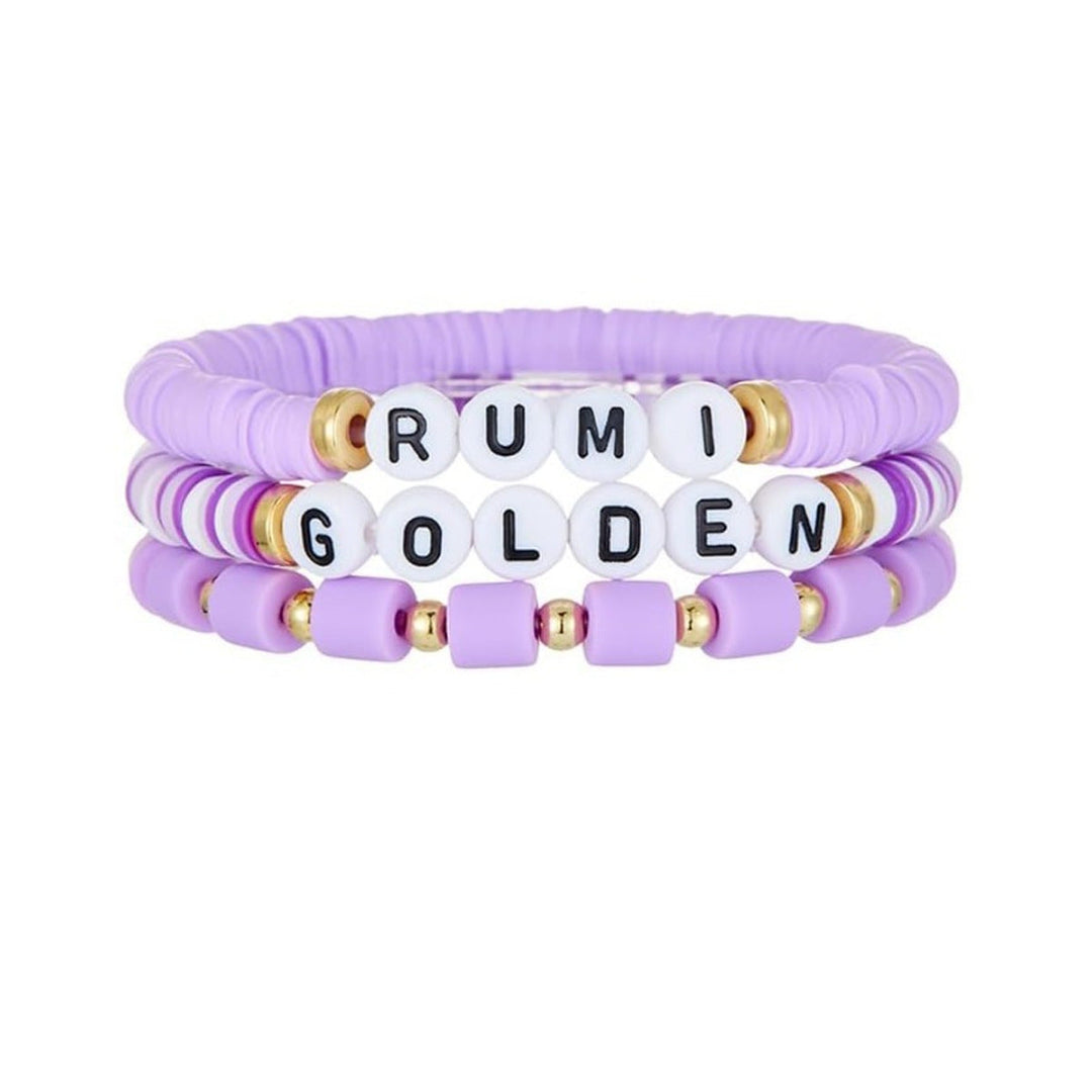 Set of three purple beaded bracelets with letter beads on a white background