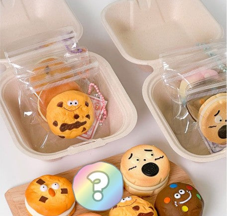 Animated cookies on a keychain with various expressions in small containers on a light background