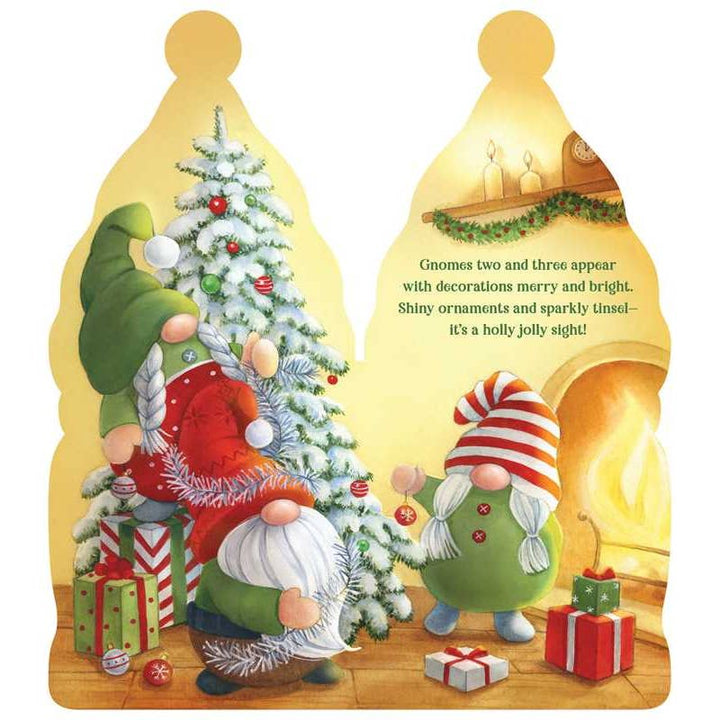 Christmas-themed book with gnomes around a decorated tree and fireplace.