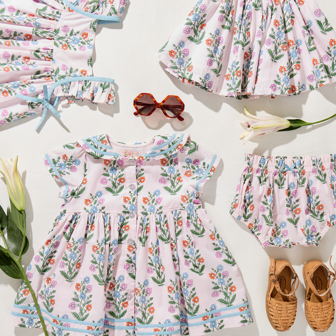 Children's floral dress with matching accessories on a white background