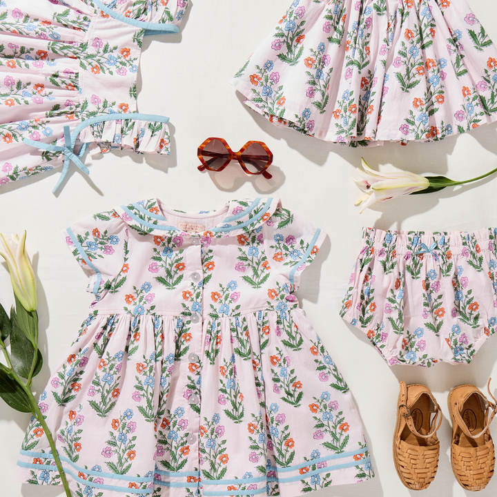 Children's floral dress with matching accessories on a white background