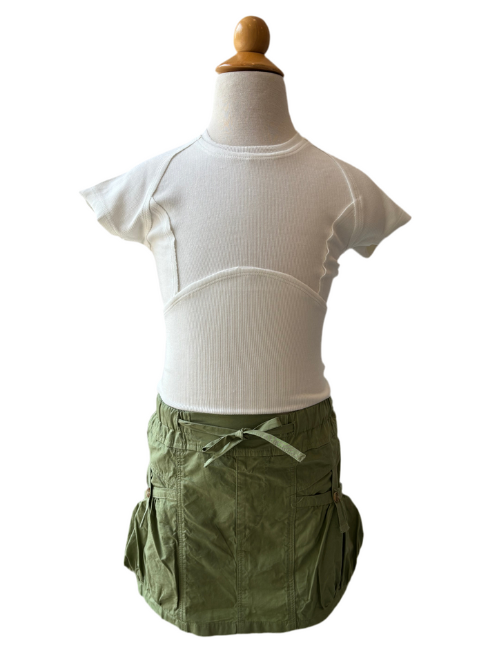 Mannequin wearing a white shirt and green skirt