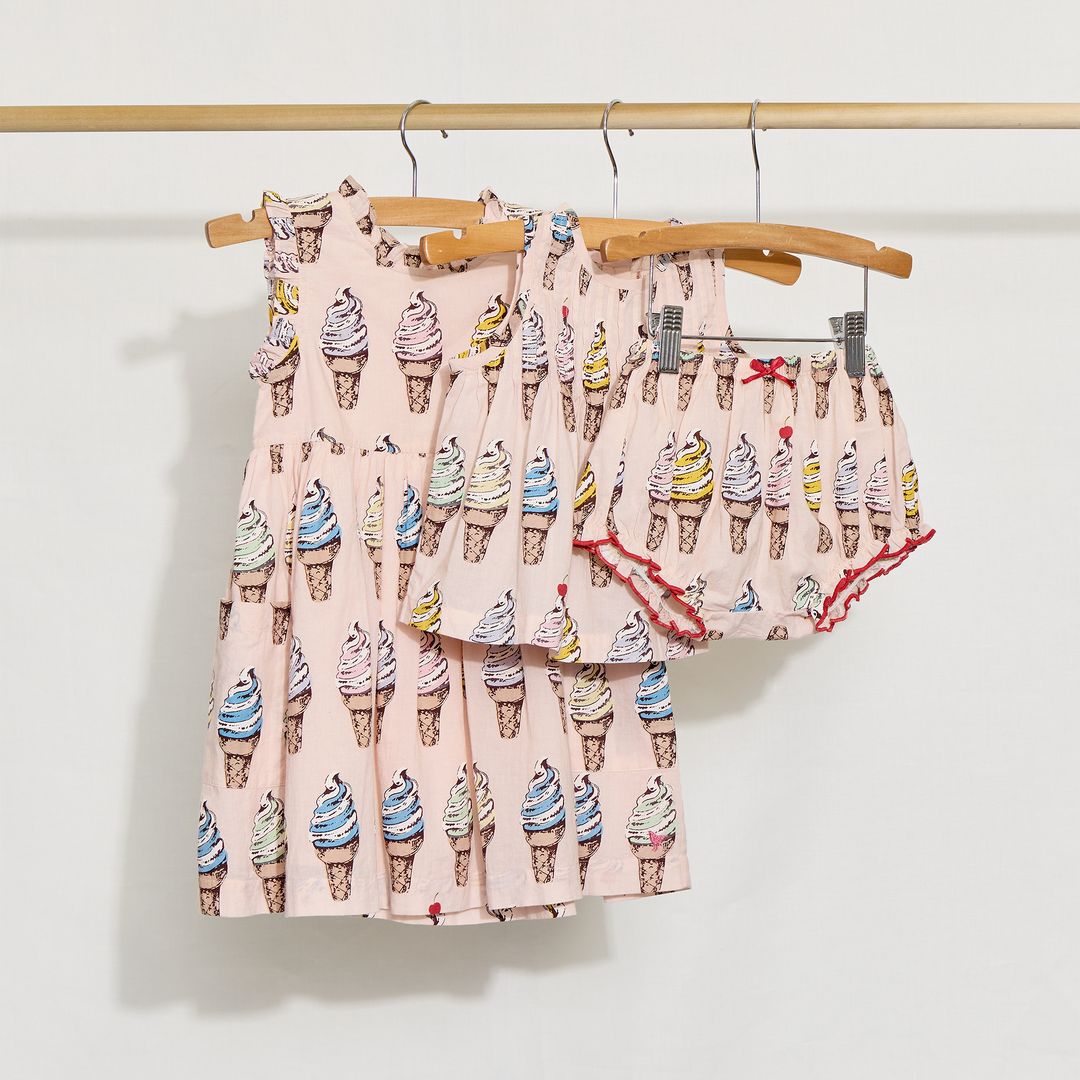 Children's dress and 2 piece set with ice cream cone pattern on a wooden hanger against a white background