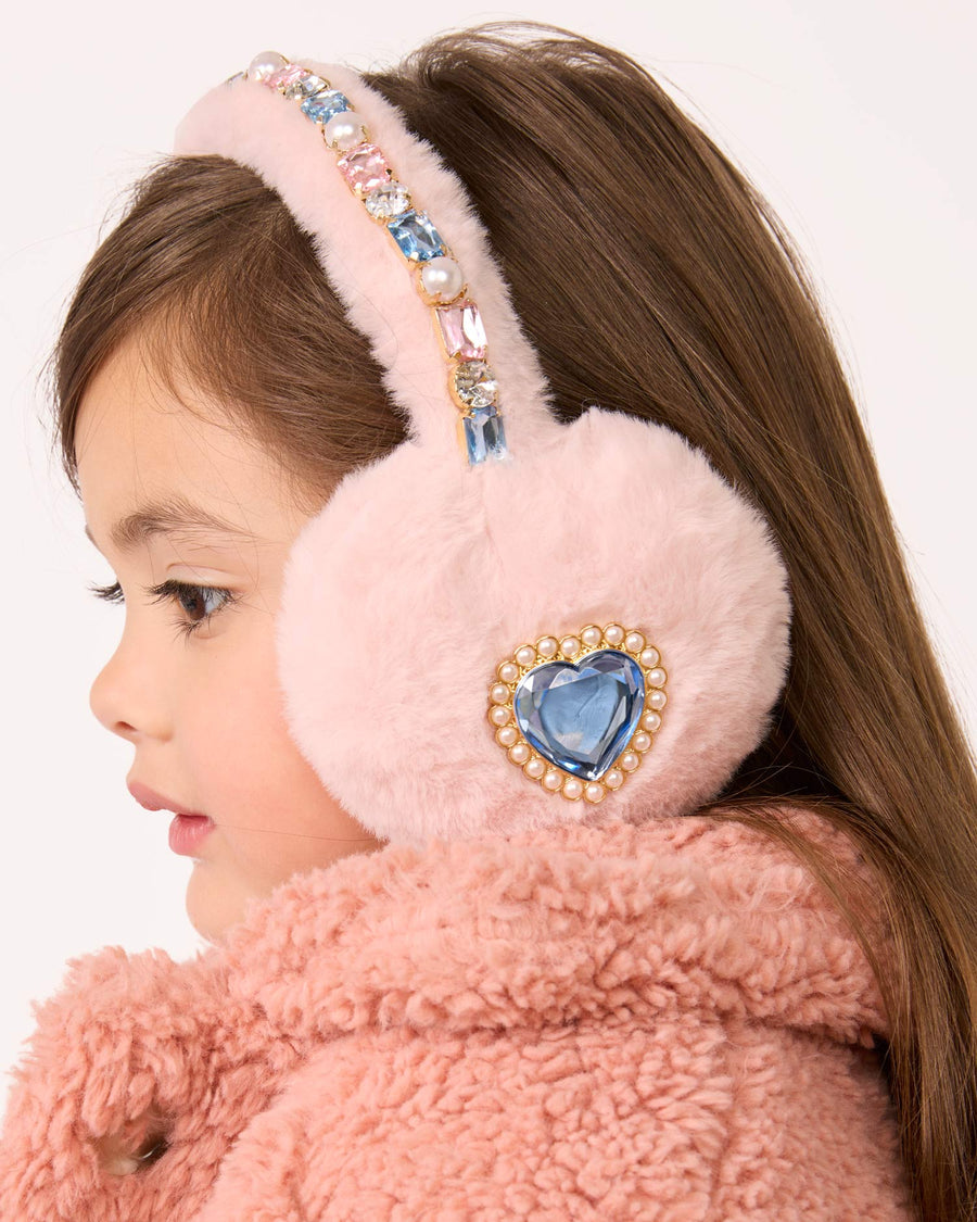 Child wearing pink fur earmuffs with decorative elements on a white background