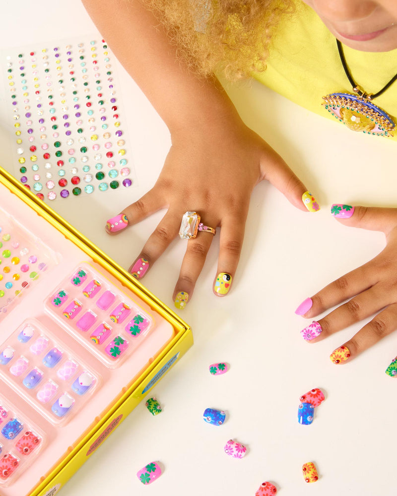 child modeling the kinds of nails you can press on and how they look on her nails. 