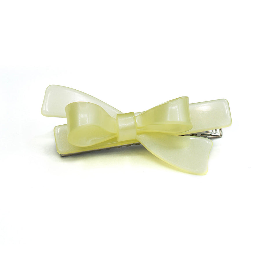 Yellow bow hair clip on a white background