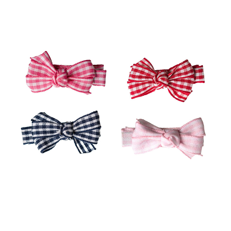 Four gingham checkered hair bows in red, blue, and pink on a white background