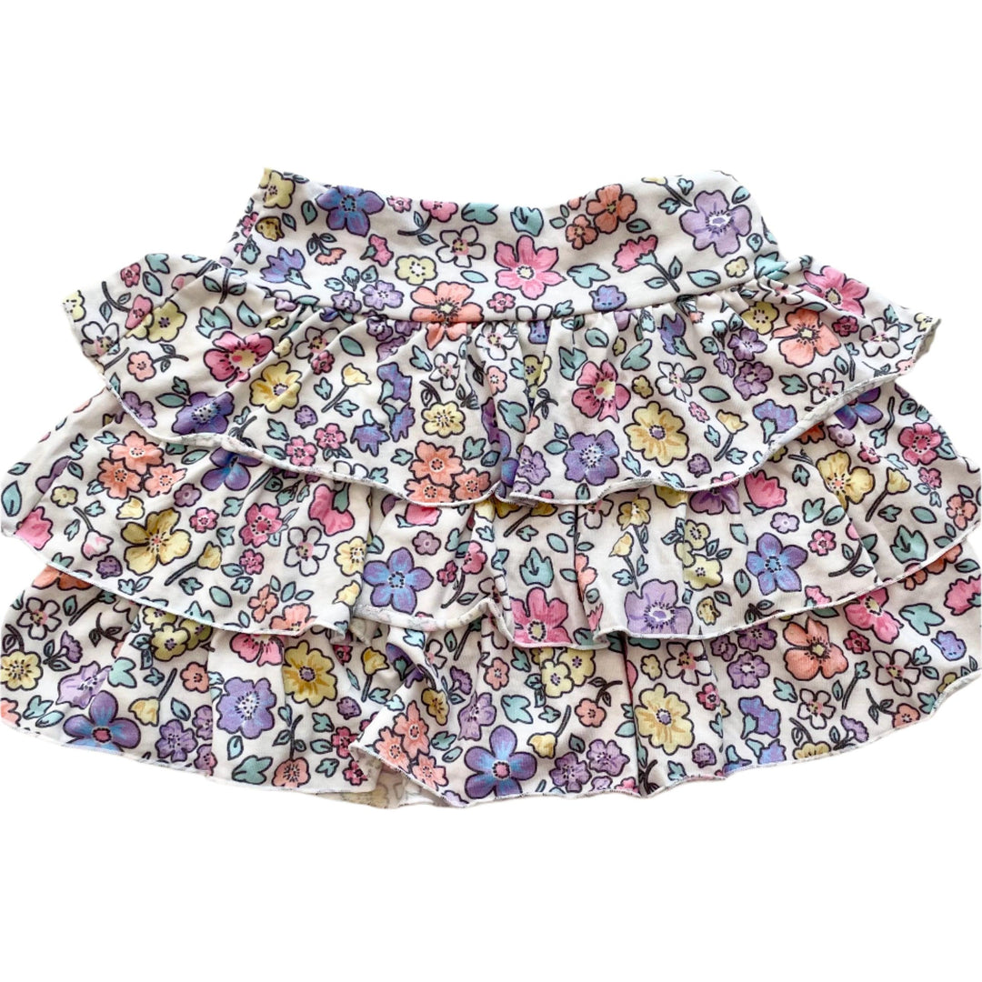 pastel floral skirt with multi tiered ruffles and waist band. flowers are all different pastel shades. 