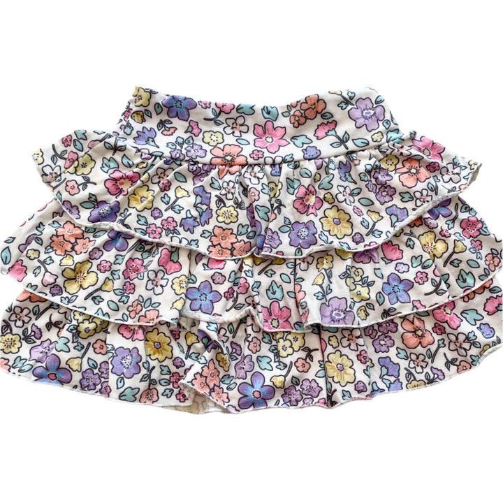 pastel floral skirt with multi tiered ruffles and waist band. flowers are all different pastel shades. 