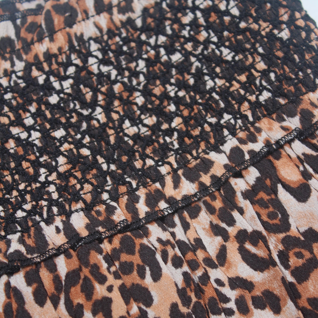 Close-up of leopard print fabric with visible stitching