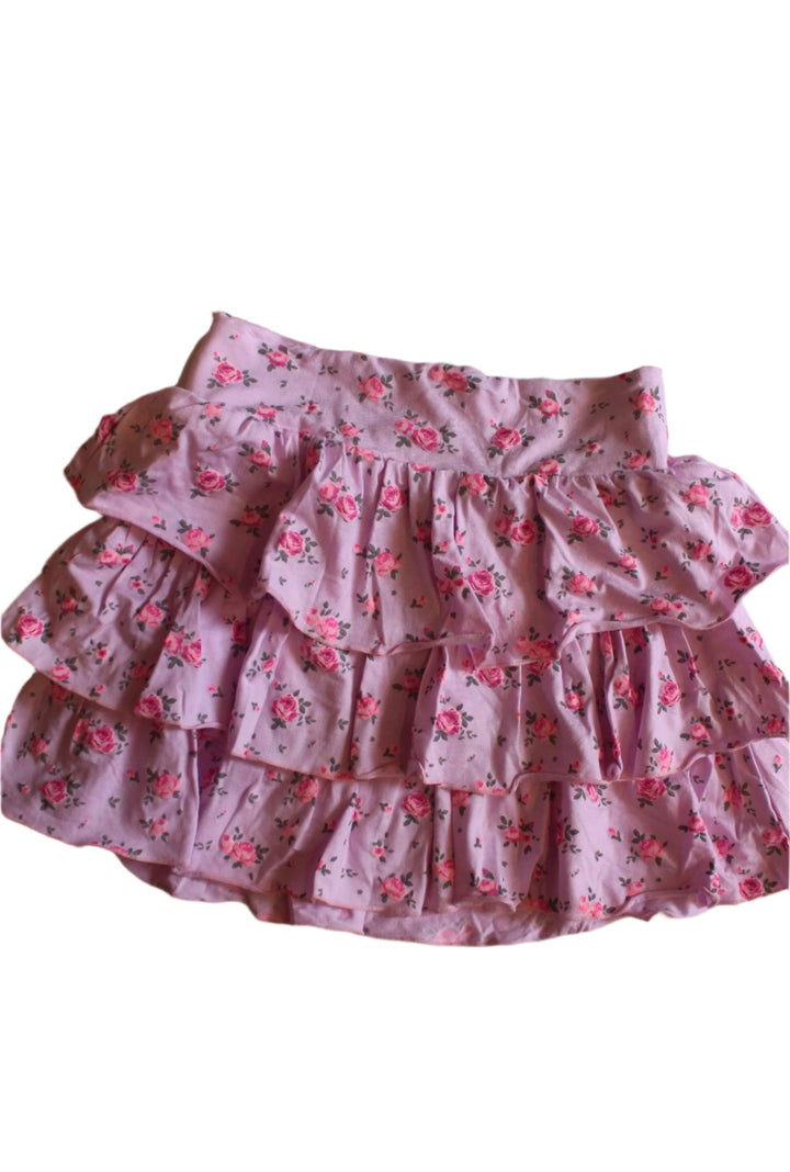 pink skirt with three ruffles on the skirt with hot pink tiny roses all over. 