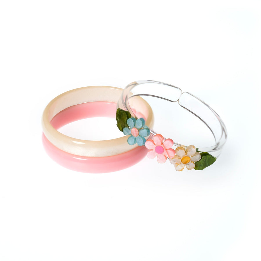 Three bangles with floral designs on a white background