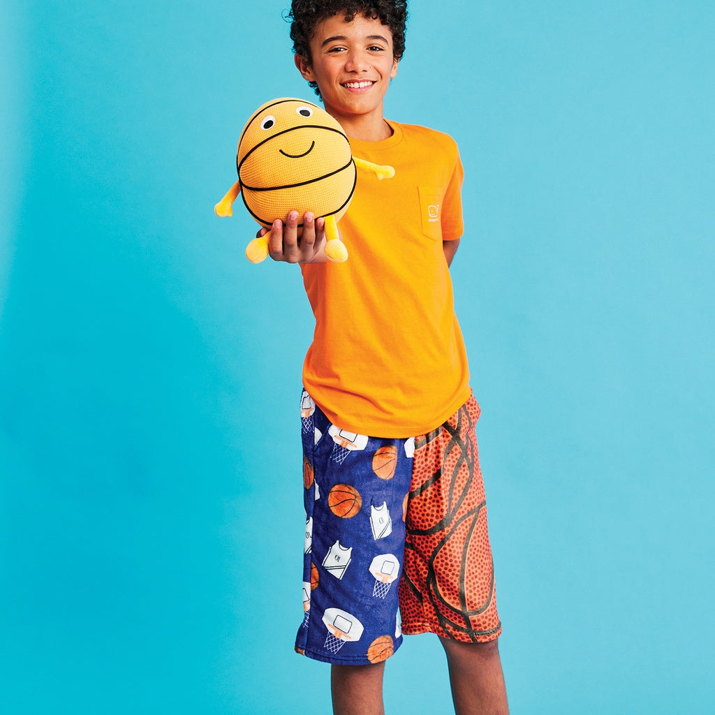 Child holding a plush toy with a blue background