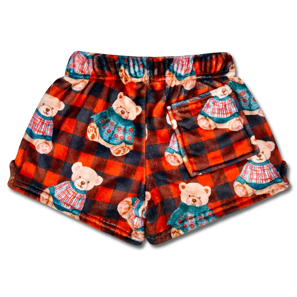 Plaid shorts with teddy bear pattern on a white background
