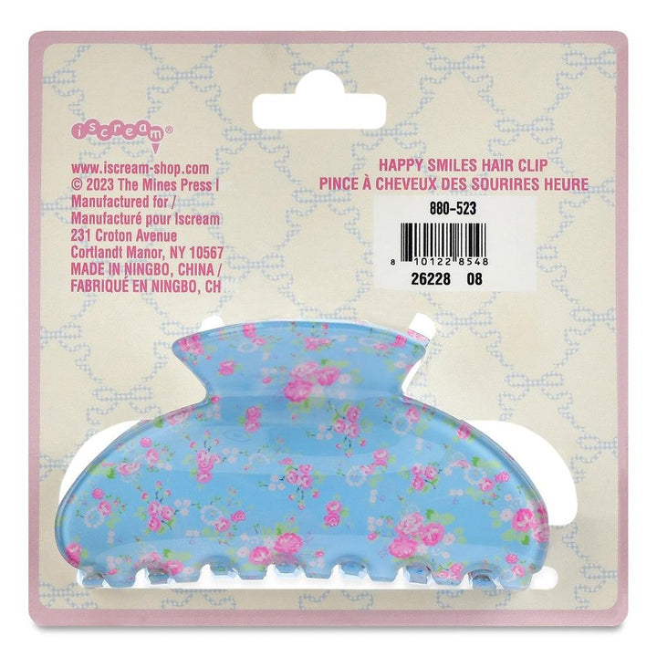 blue claw clip with tiny pink floral print all over attached to a car with manufacturing information. 