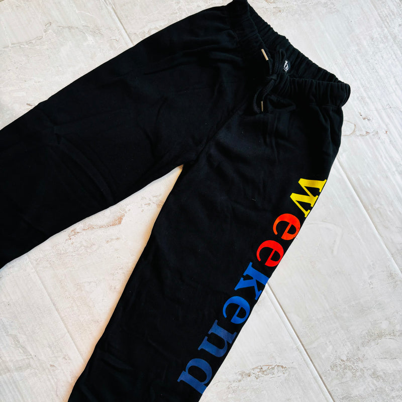 Black Sweatpant that features a graphic with the word WEEKEND in rainbow colors by Flowers by Zoe