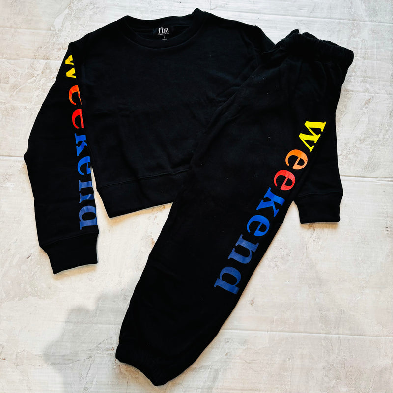 Black Sweatsuit that features the graphic WEEKEND in rainbow colors on sleeve of top and on leg of sweatpant from Flowers by Zoe