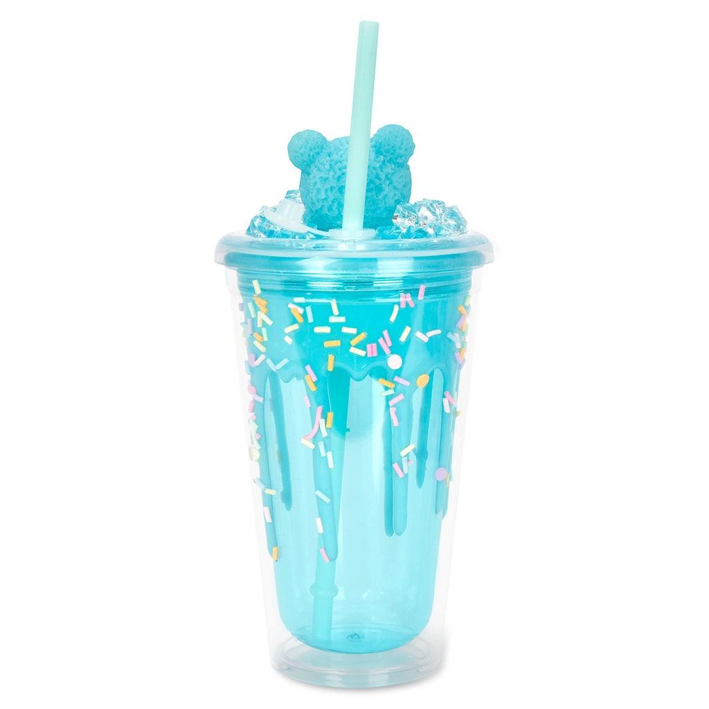 plastic tumbler with sprinkles in the cup and a bear sitting on the lid. this picture shows what the cup looks like from the back. 