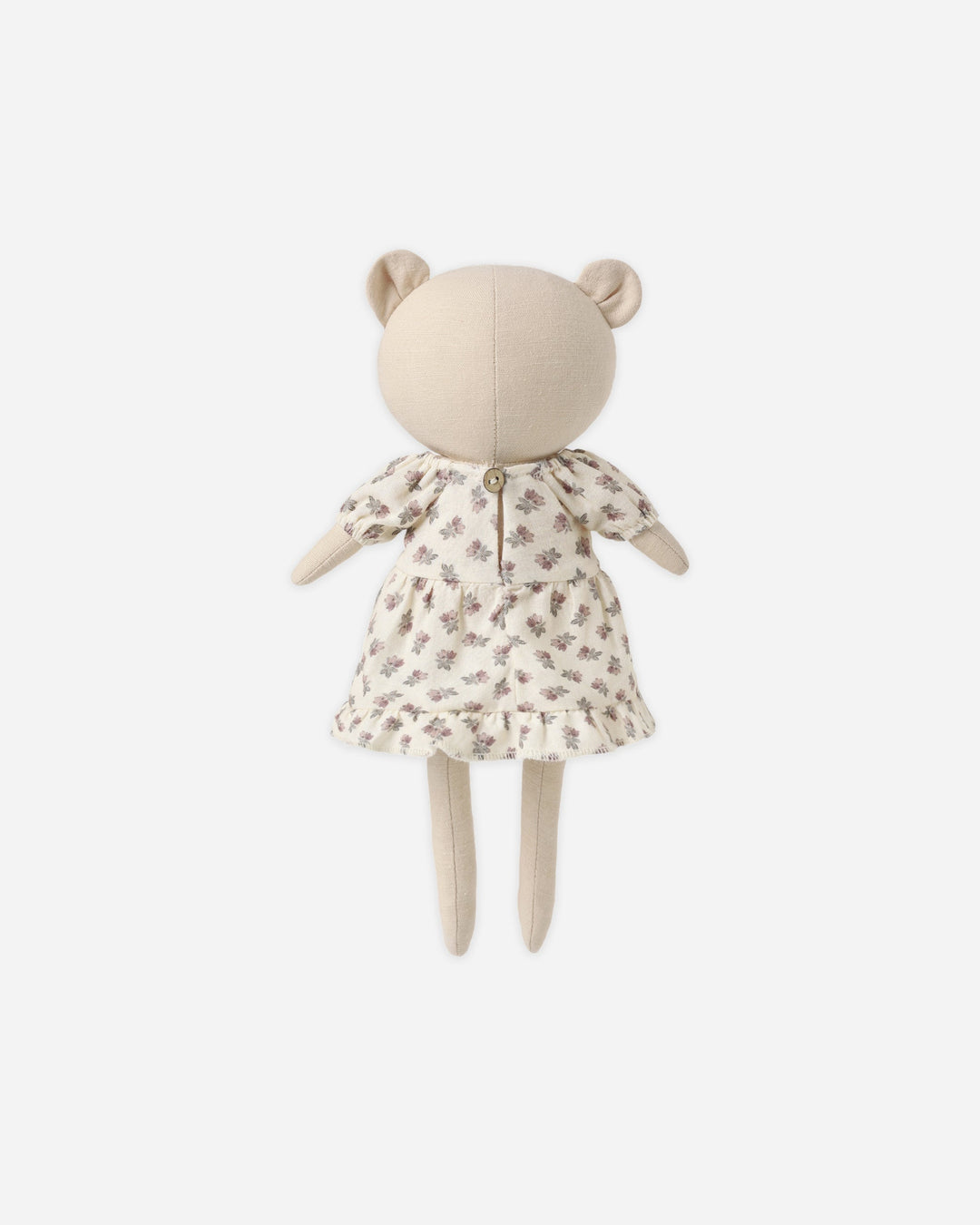 A plush teddy bear doll with a cream-colored fabric body and a short cream dress covered in a small brown floral pattern, shown against a plain light gray background.