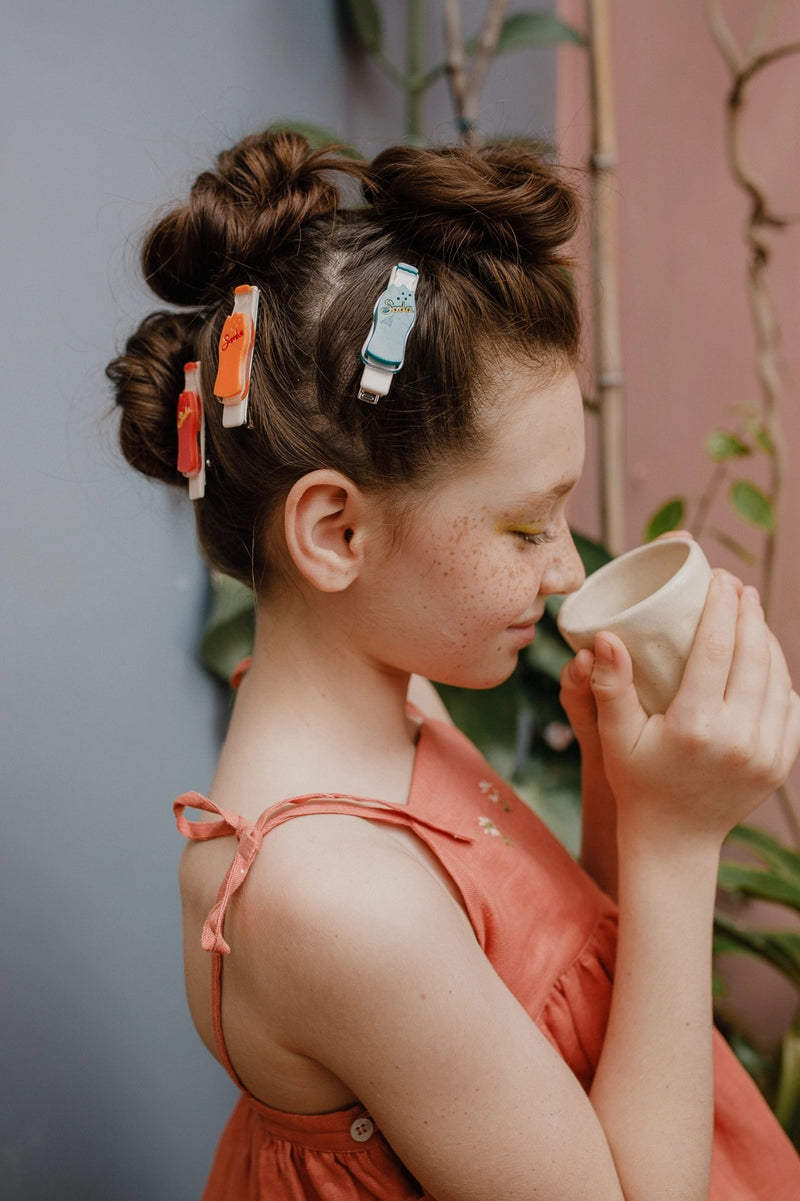 Girl wearing all three bottle clips from Lilies and Roses NY