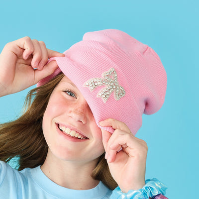 girl modeling the pink beanie with a rhinestone bow