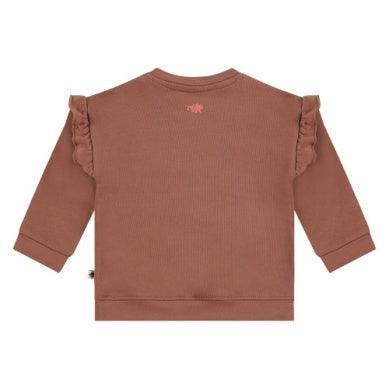 brown sweatshirt with ruffles on the shoulders. brown fuzzy bear on the center. 