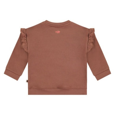 brown sweatshirt with ruffles on the shoulders. brown fuzzy bear on the center. 