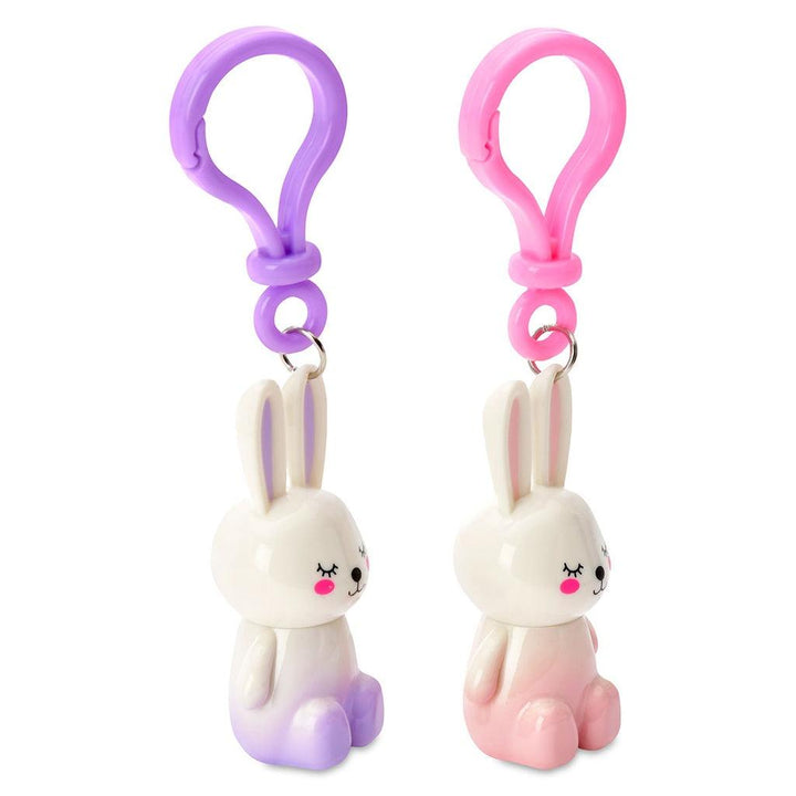 bunny lip gloss attached to the keychain. one pink and one purple. bunnies turned to the side. 