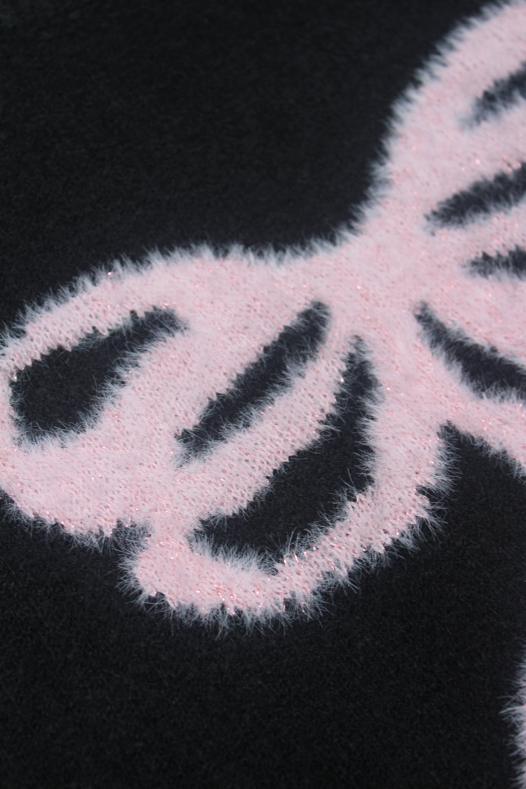 Close-up of a bow pattern on a black background