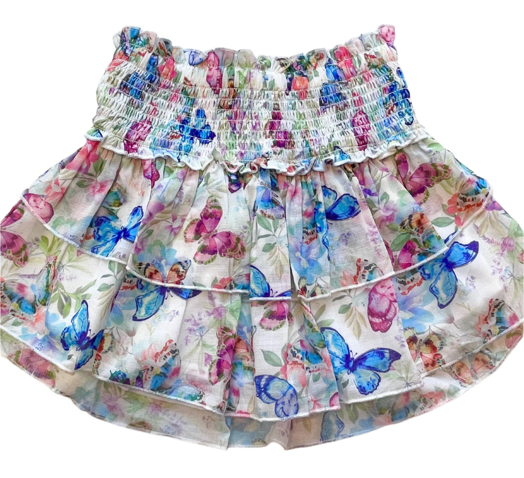skirt with smocking at the top and 2 layers of the skirt that have butterflies on them: blue, pink and magenta. 