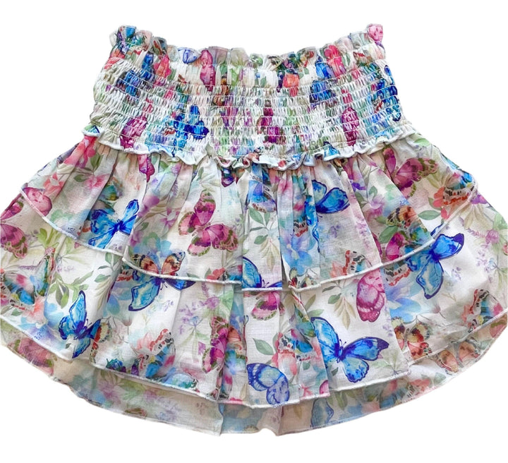 skirt with smocking at the top and 2 layers of the skirt that have butterflies on them: blue, pink and magenta. 