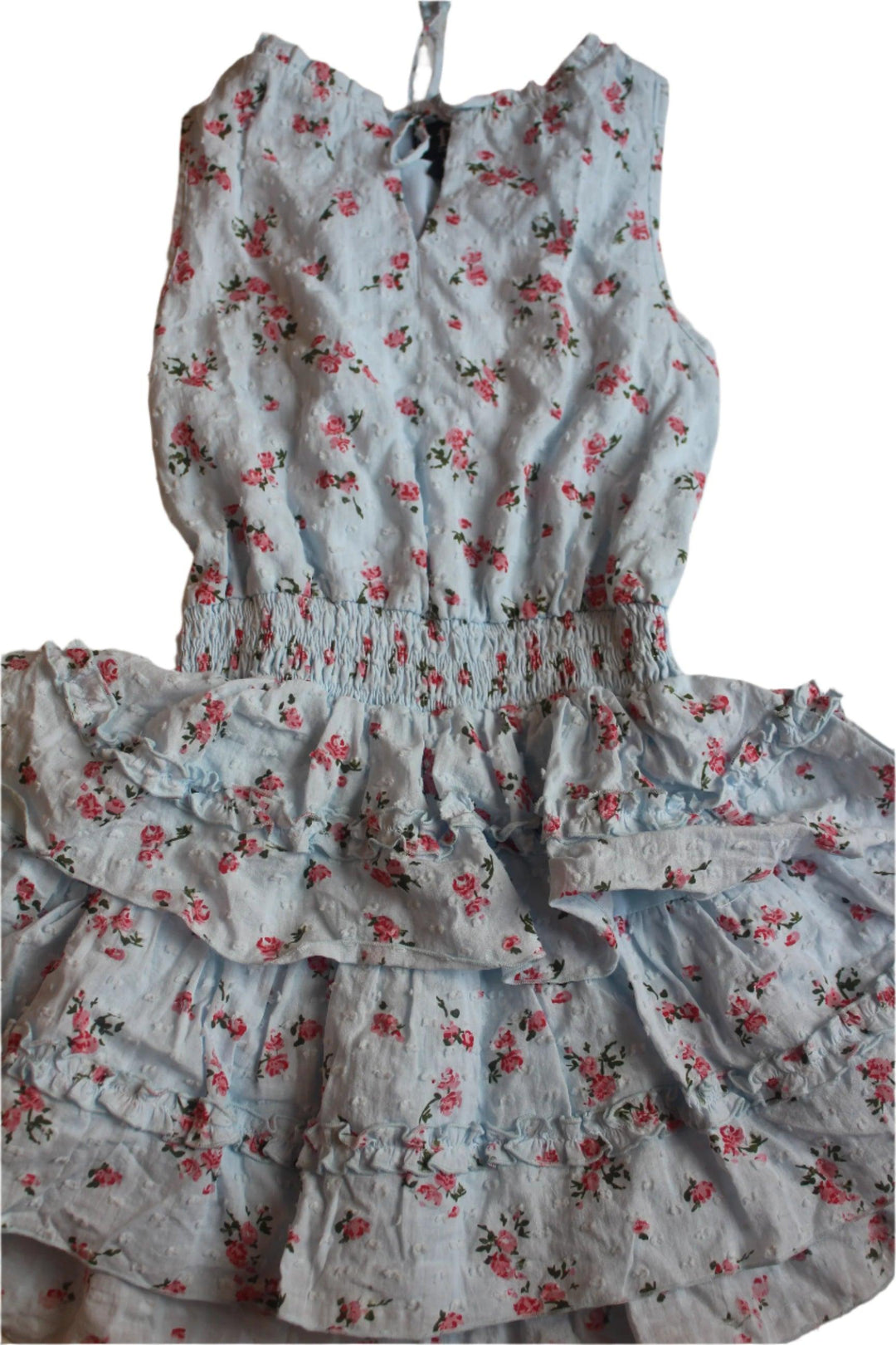 Girls Dress with light blue base and tiny pink flowers all over. sleeveless dress with a notch in the top of the dress that ties. elastic waist and tiered skirt. 
